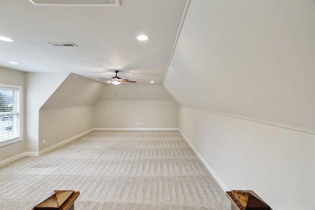 bonus room featuring baseboards, lofted ceiling, visible vents, and light colored carpet