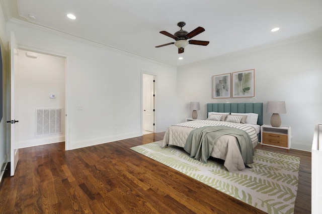 bedroom featuring visible vents, crown molding, and wood finished floors