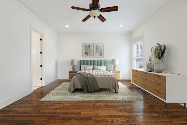 bedroom featuring baseboards, wood finished floors, and crown molding