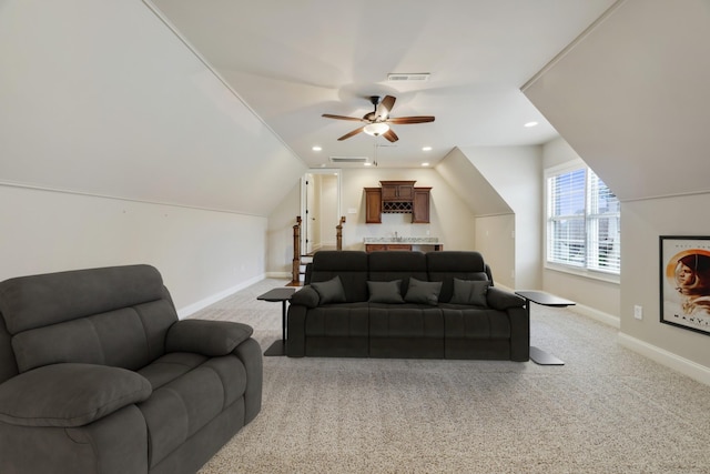 living room featuring vaulted ceiling, light carpet, visible vents, and baseboards