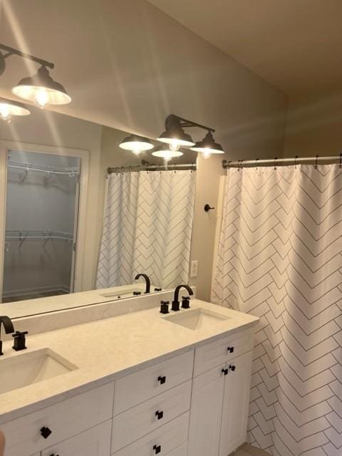 bathroom with a sink and double vanity