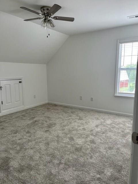 bonus room with lofted ceiling, carpet, visible vents, and baseboards