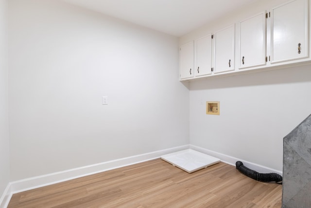 laundry room with hookup for a washing machine, light wood-style flooring, baseboards, and cabinet space