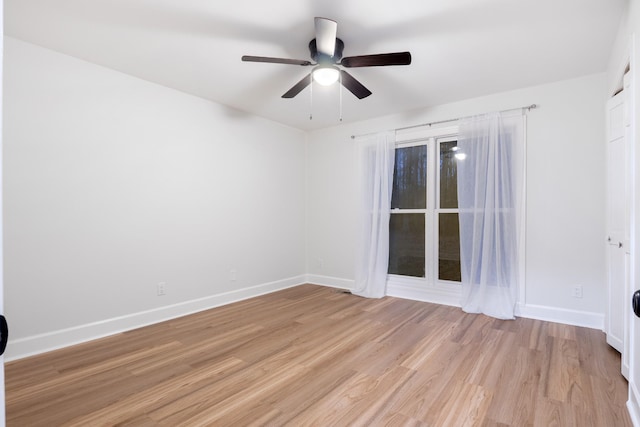 empty room with light wood-type flooring, baseboards, and a ceiling fan