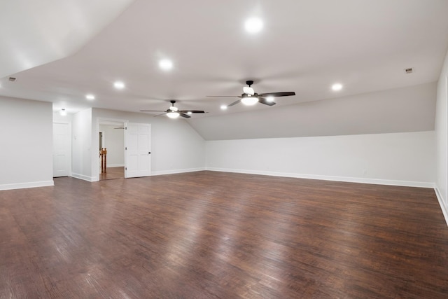 interior space with dark wood-style floors, baseboards, vaulted ceiling, and recessed lighting