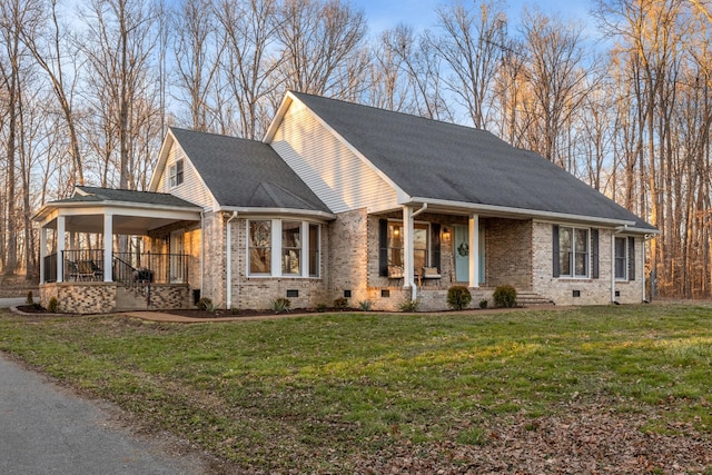 view of front of home featuring a front yard, crawl space, covered porch, and brick siding