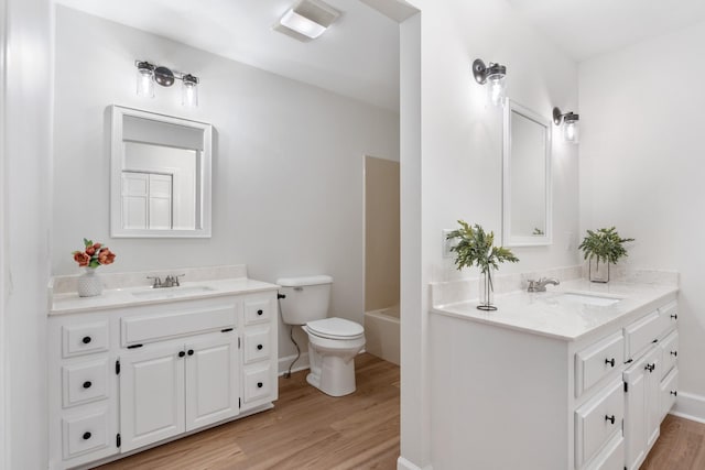 bathroom featuring wood finished floors, a sink, and visible vents