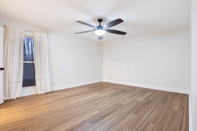 empty room with light wood-style floors, ceiling fan, and baseboards