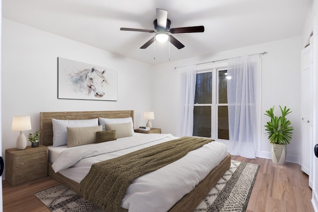 bedroom with light wood-type flooring and ceiling fan