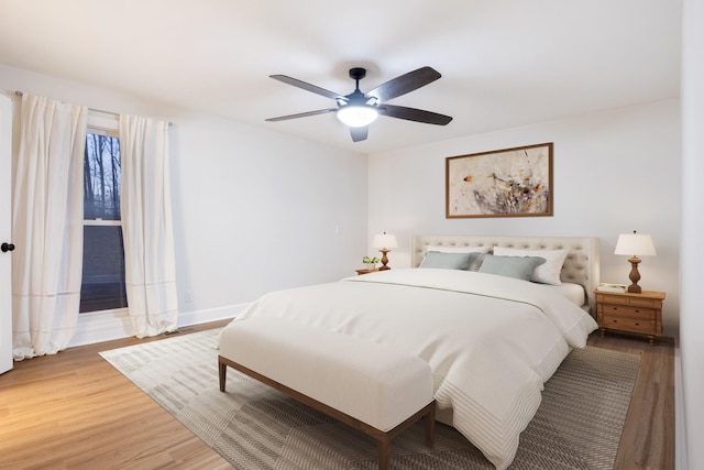 bedroom with a ceiling fan and wood finished floors