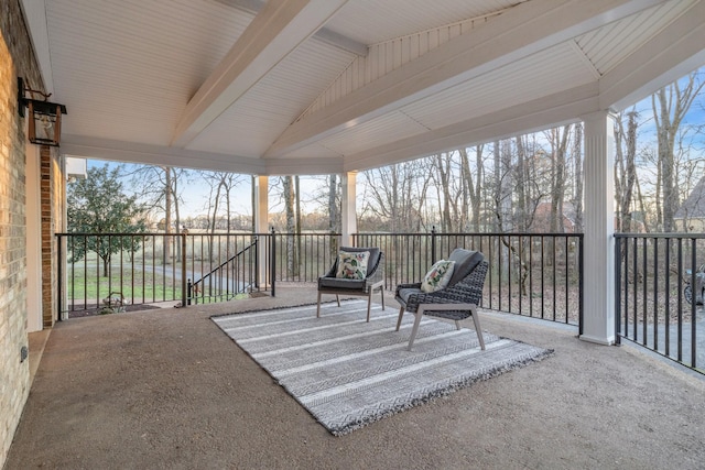 sunroom featuring lofted ceiling with beams