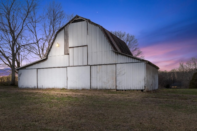 view of barn with a yard