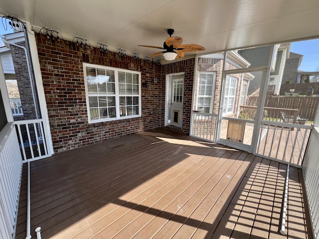 wooden terrace featuring a ceiling fan