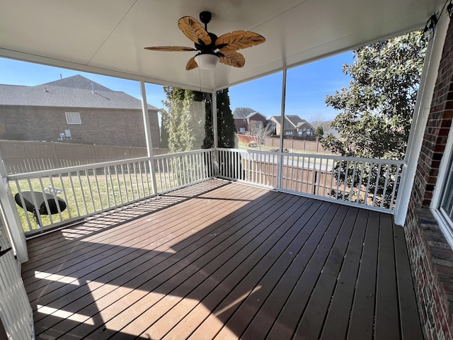 deck with a residential view, fence, and a ceiling fan