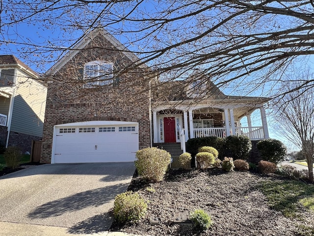 view of front facade featuring a garage, covered porch, concrete driveway, and brick siding