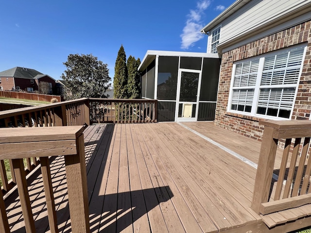 wooden deck featuring a sunroom