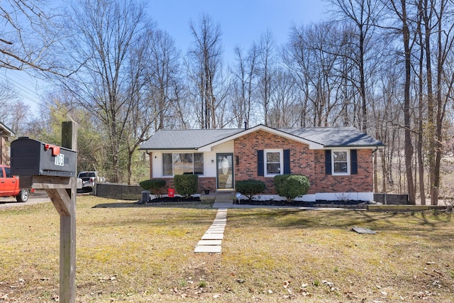 view of front facade with a front lawn and brick siding