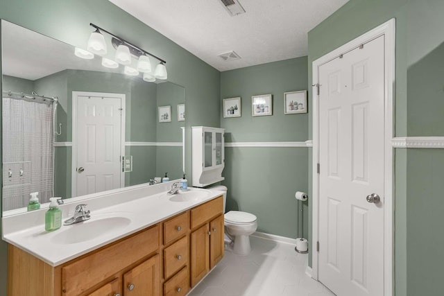 bathroom featuring visible vents, a sink, and double vanity