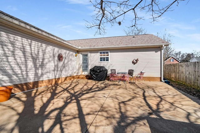 back of property with a patio area and fence