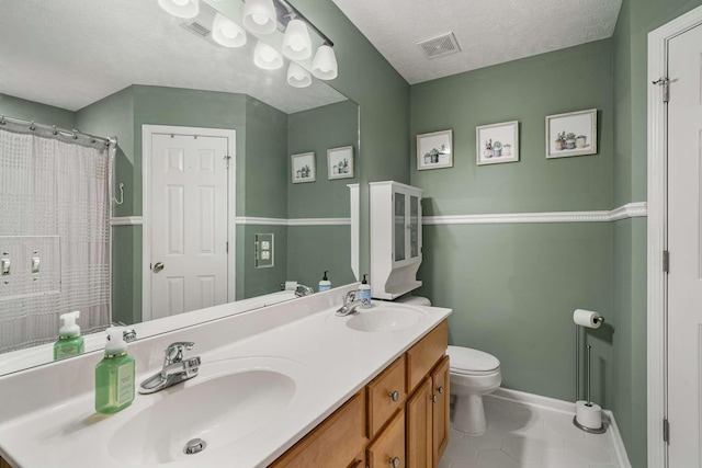 bathroom with visible vents, a sink, and toilet