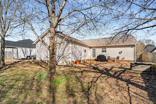 back of property with a patio area and fence