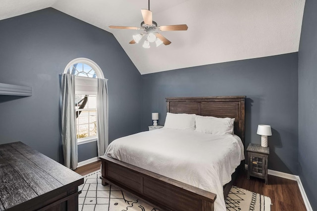 bedroom featuring light wood-style floors, multiple windows, and vaulted ceiling