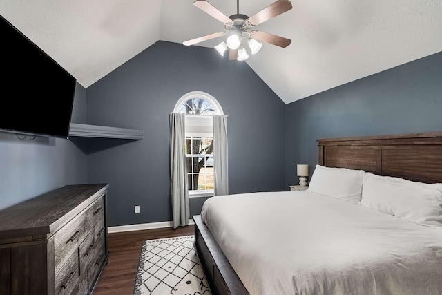 unfurnished bedroom featuring lofted ceiling, ceiling fan, multiple windows, and dark wood-type flooring