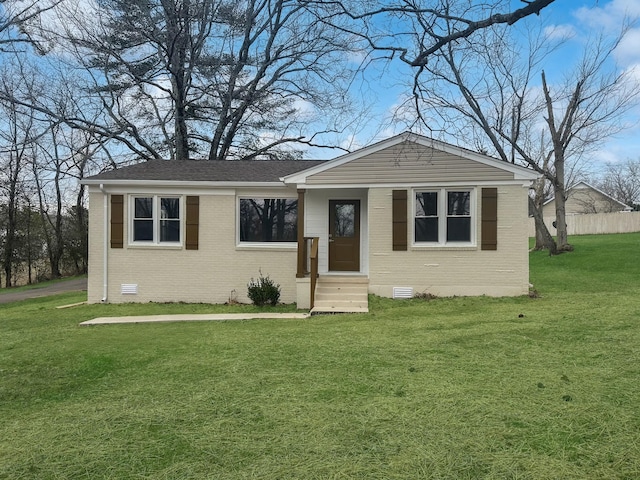 view of front of house featuring crawl space, brick siding, a front yard, and entry steps