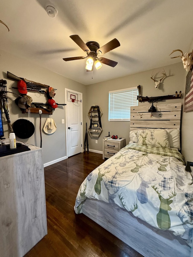 bedroom with wood finished floors, a ceiling fan, and baseboards