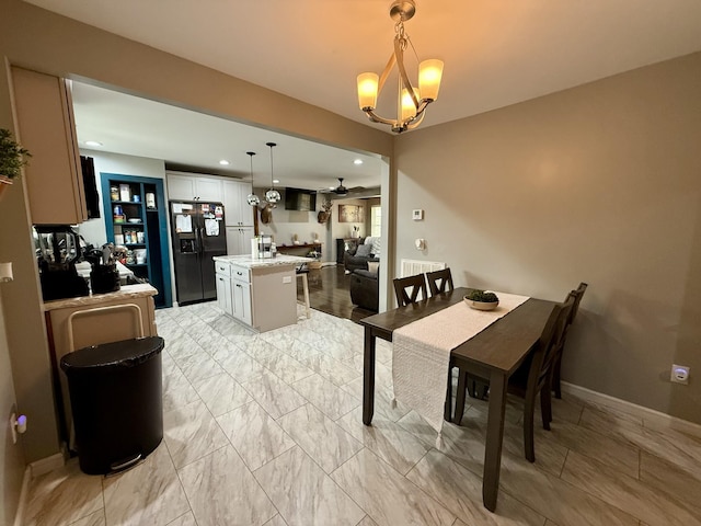 dining space featuring recessed lighting, marble finish floor, baseboards, and ceiling fan with notable chandelier