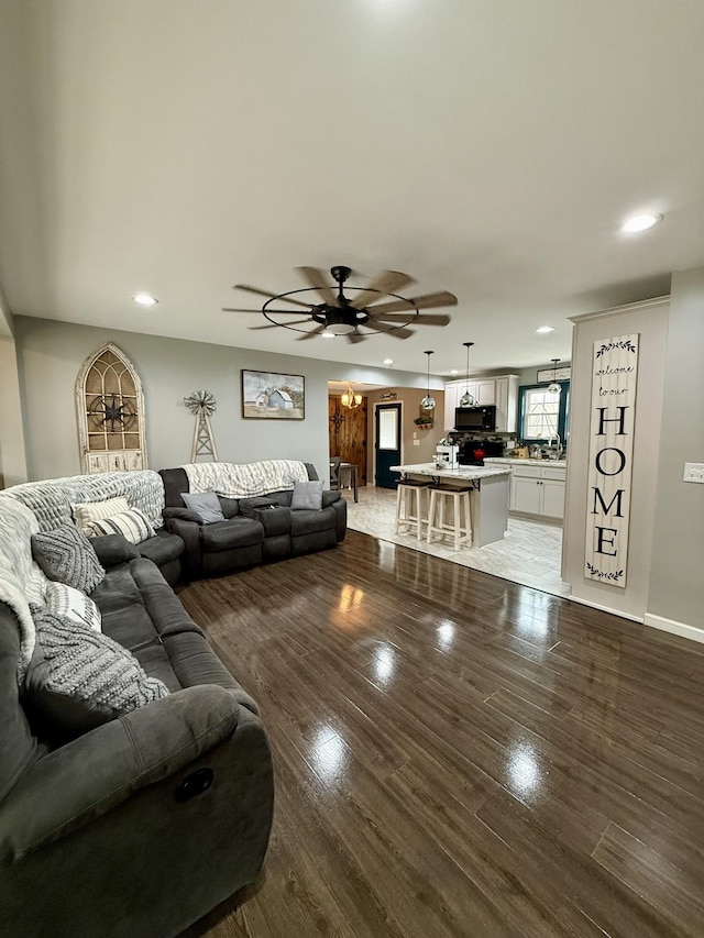 living area featuring recessed lighting, ceiling fan, and wood finished floors