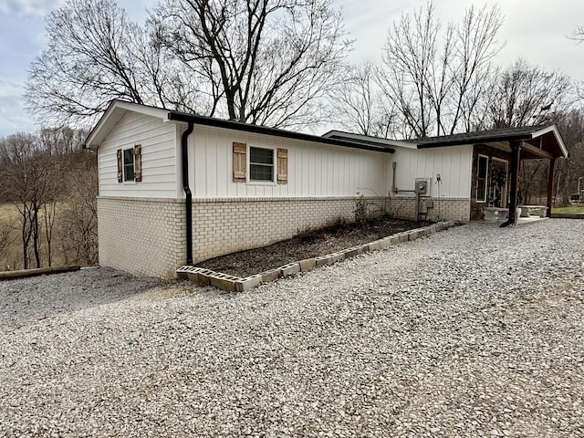 view of home's exterior with driveway and brick siding