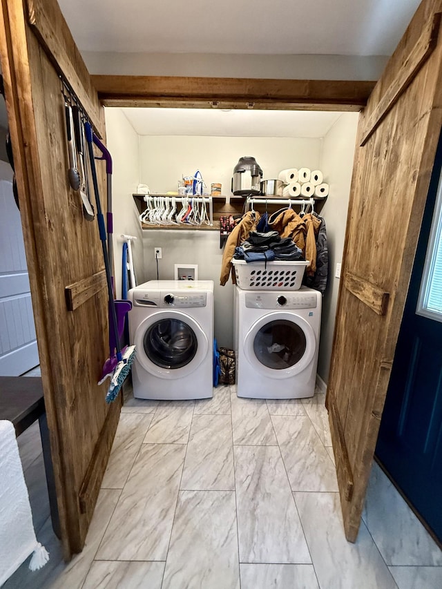 laundry area featuring laundry area, marble finish floor, and washing machine and clothes dryer