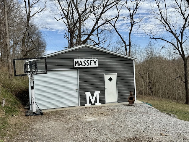 view of outbuilding with driveway and an outbuilding