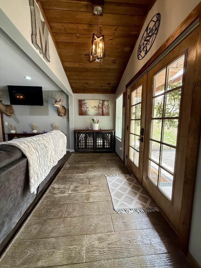 interior space with french doors, lofted ceiling, wood ceiling, wood finished floors, and baseboards