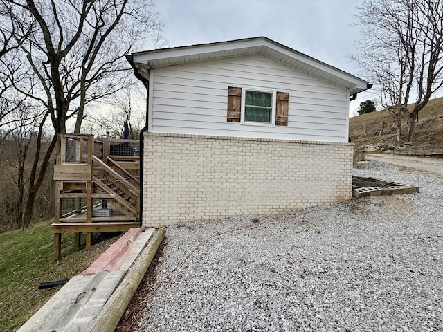 view of side of home featuring brick siding