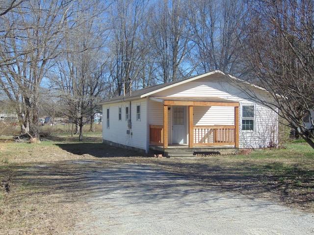 bungalow featuring driveway and a porch