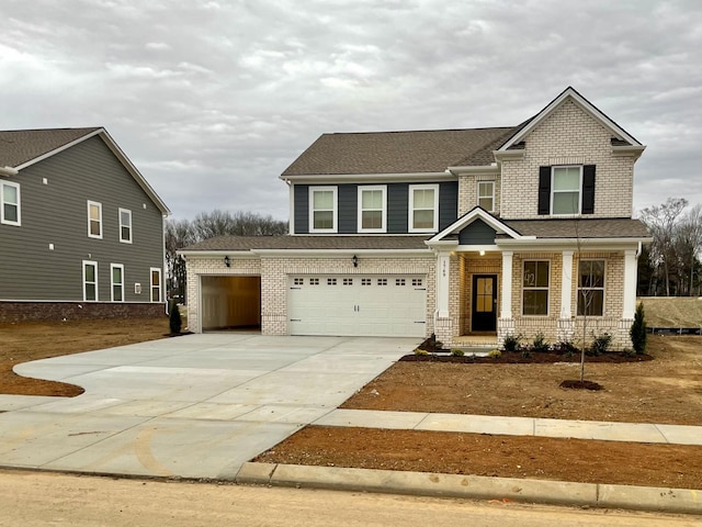 craftsman inspired home featuring concrete driveway, brick siding, and an attached garage