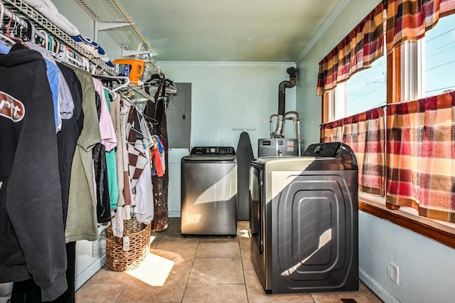 washroom featuring laundry area, baseboards, washer and clothes dryer, ornamental molding, and tile patterned floors