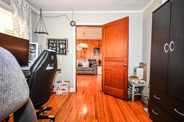 home office featuring ornamental molding and wood finished floors