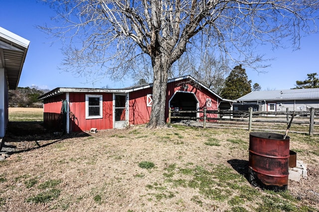 exterior space with fence and an outbuilding