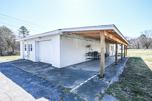 garage featuring driveway and a detached garage