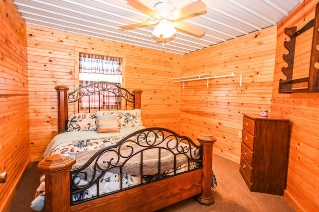 bedroom with carpet floors and wooden walls