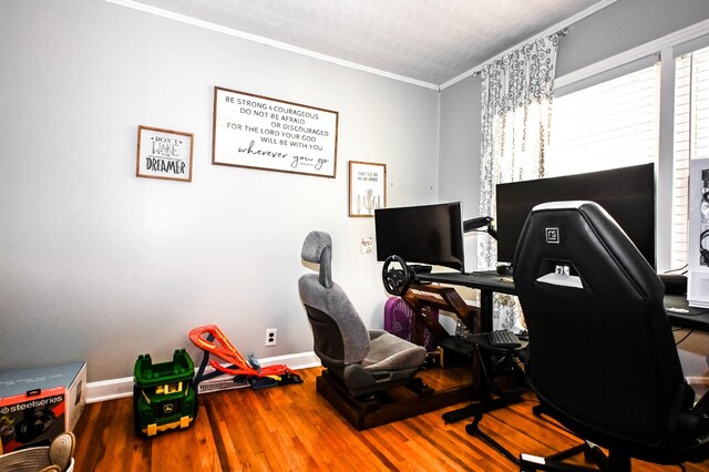 office featuring baseboards, crown molding, and wood finished floors