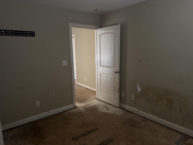 unfurnished room featuring baseboards