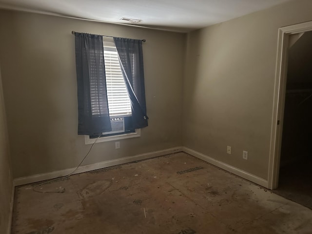 unfurnished room with visible vents and baseboards