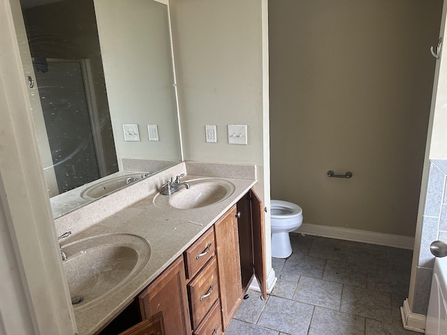 full bath featuring double vanity, a sink, and baseboards