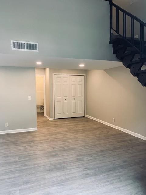 interior space with baseboards, visible vents, wood finished floors, and recessed lighting