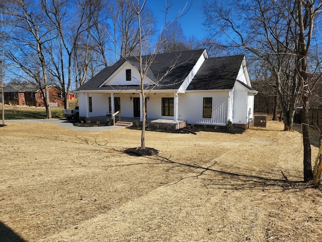 modern farmhouse with covered porch and central air condition unit