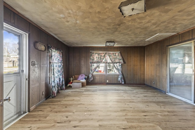 empty room with wood walls and light wood-style flooring